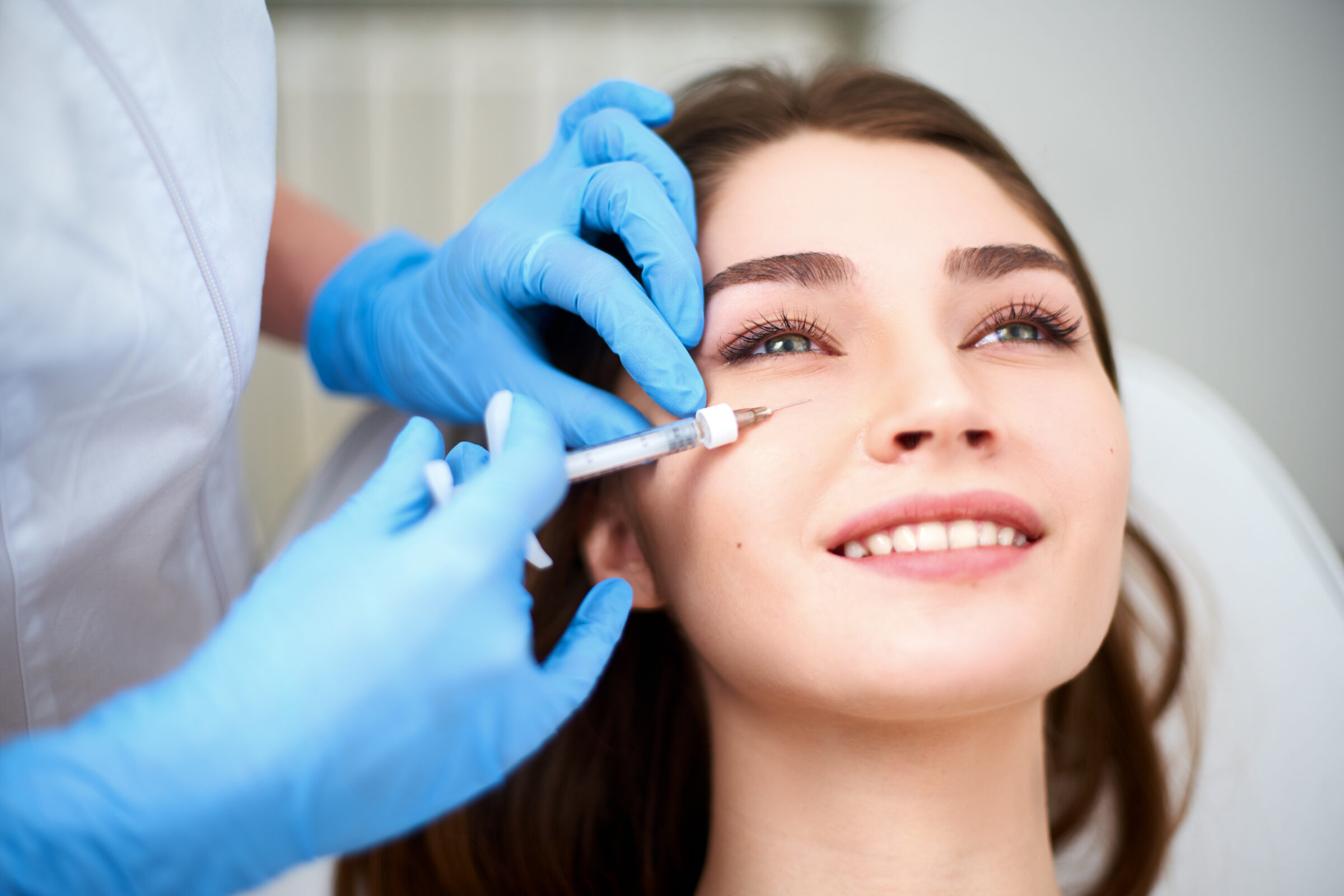 A woman getting an undereye filler injection